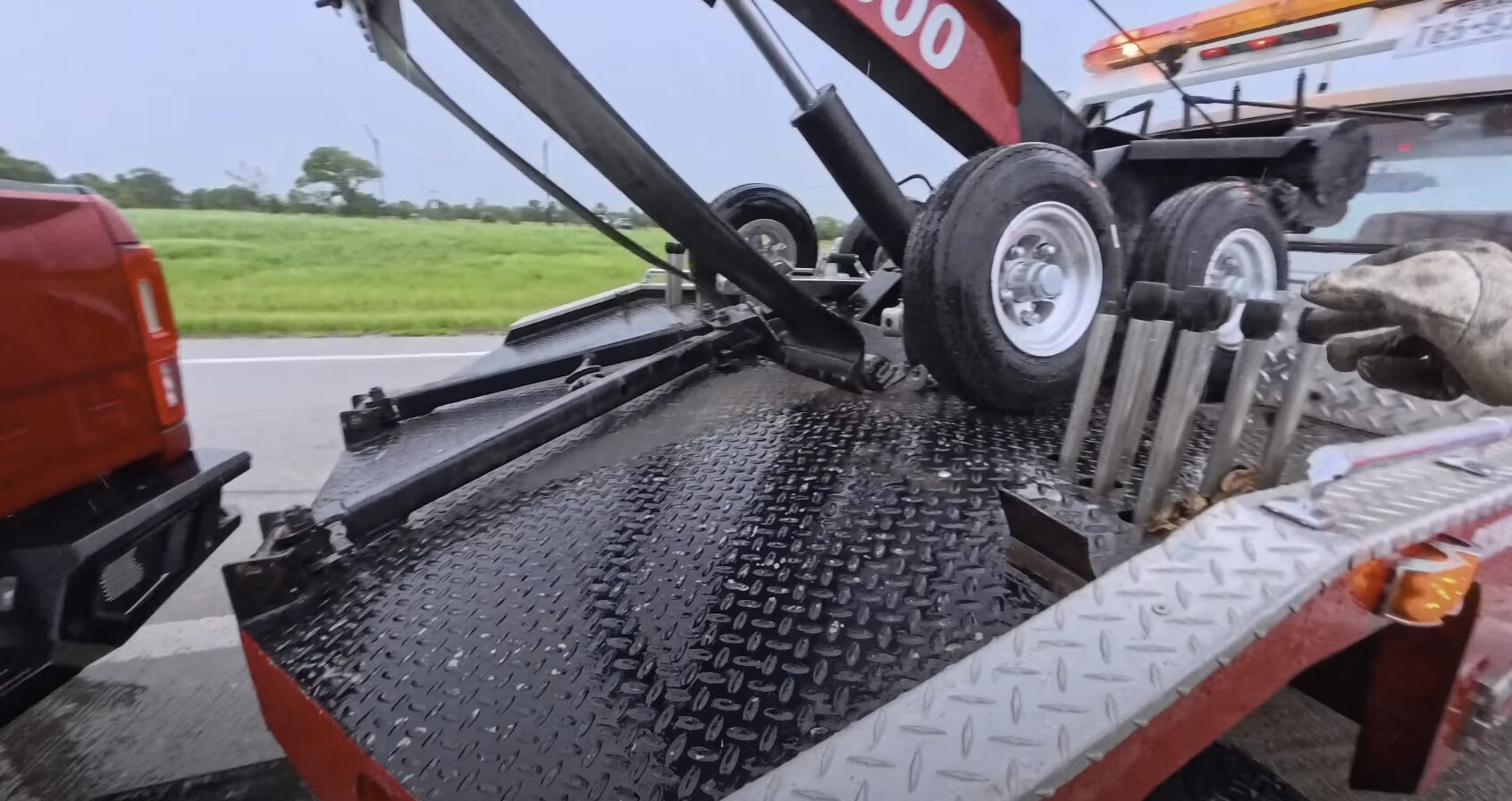 Professional Flatbed Towing Equipment and Techniques Professional tow truck operator loading vehicle using proper flatbed towing techniques